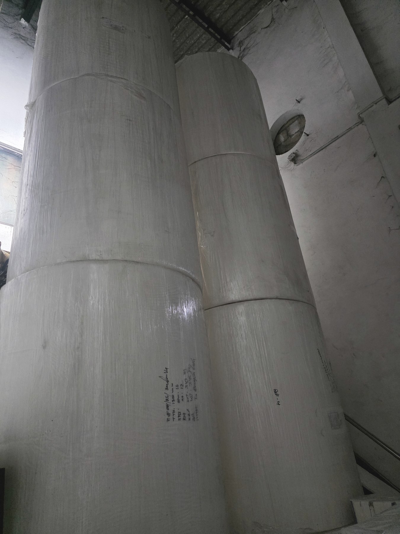 Large imported paper rolls stacked in storage